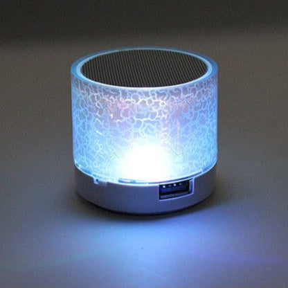 Small cylindrical light with mosaic design on a dark background