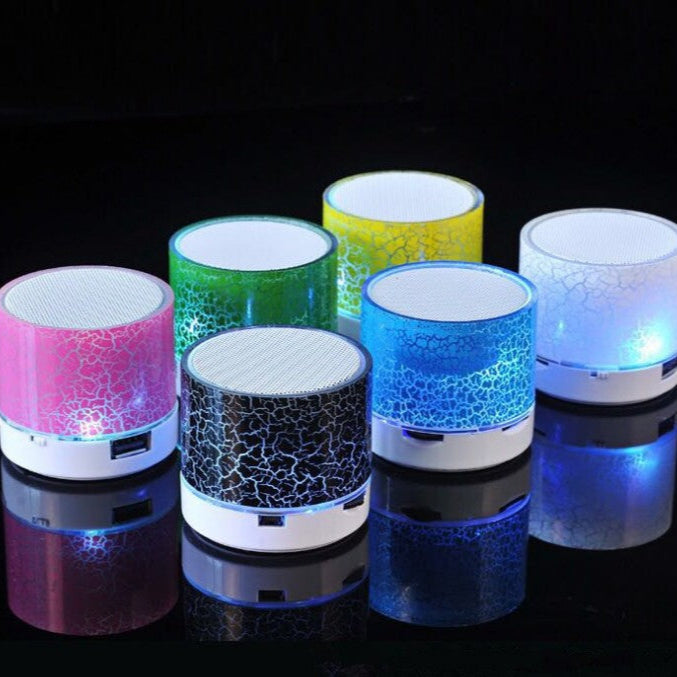 Colorful LED lights of Mini  Bluetooth Wireless Speakers on a black background